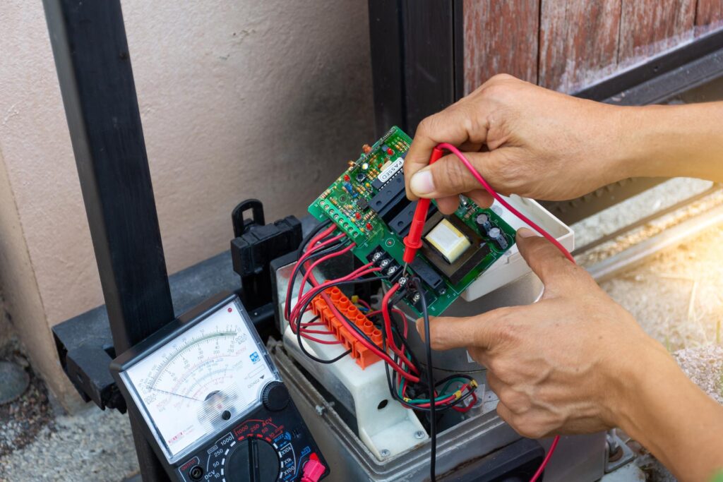 ParkPro technician repairing an automatic gate motor at a Phoenix AZ property