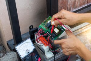 ParkPro technician repairing an automatic gate motor at a Phoenix AZ property