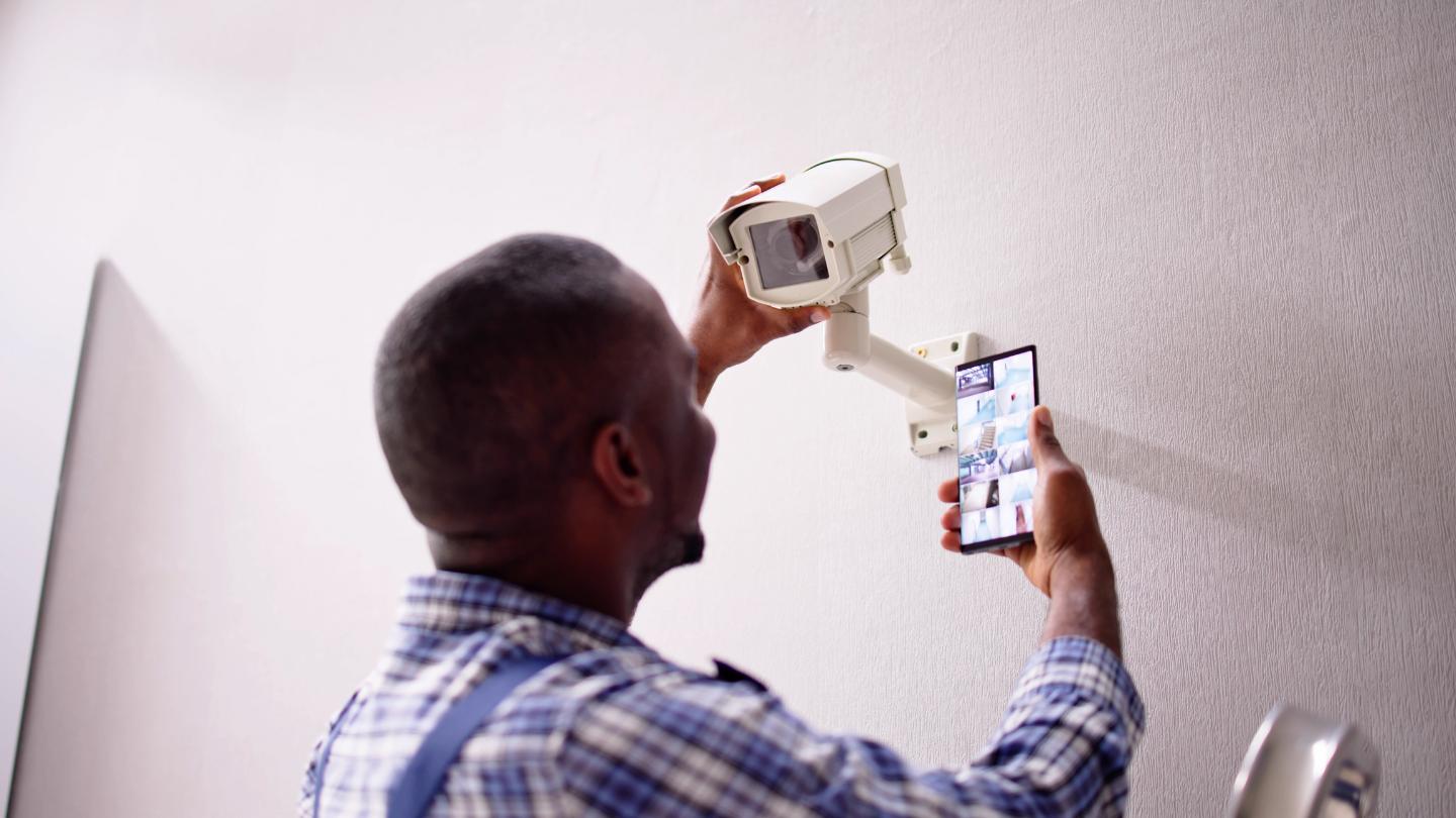 ParkPro installation team testing surveillance system feed after camera installation in Phoenix AZ